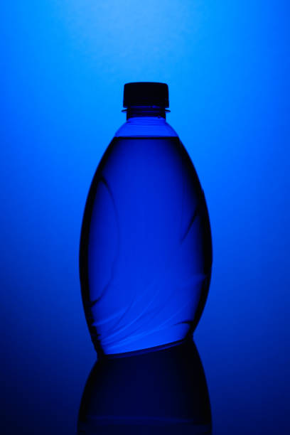 blue plastic bottle on the blue background. - soda supermarket stockfoto's en -beelden