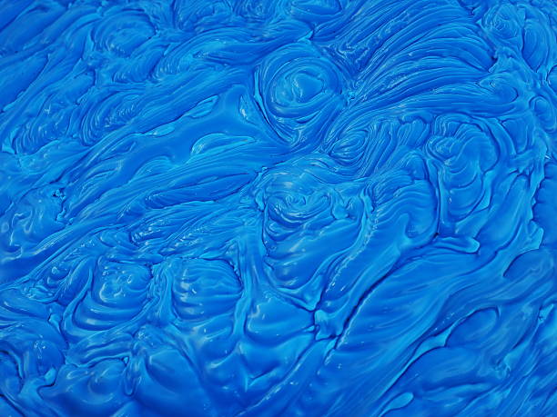 Blue polymer mass with wave like patterns stock photo