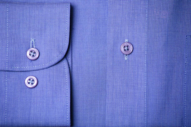 Blue shirt Sleeve and butons detail on a blue elegant shirt. button down shirt stock pictures, royalty-free photos & images