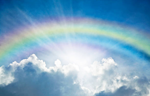 Blue Sky With Rainbow and Sun Reflection stock photo