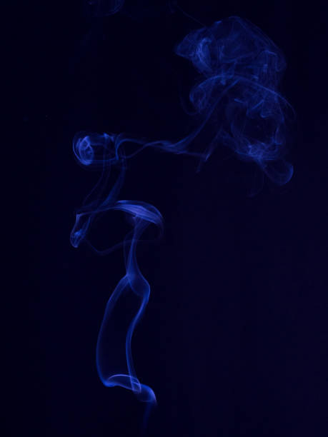 Blue smoke on dark background stock photo