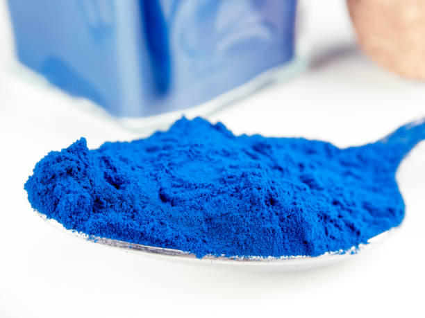Blue Spirulina powder, isolated on white stock photo