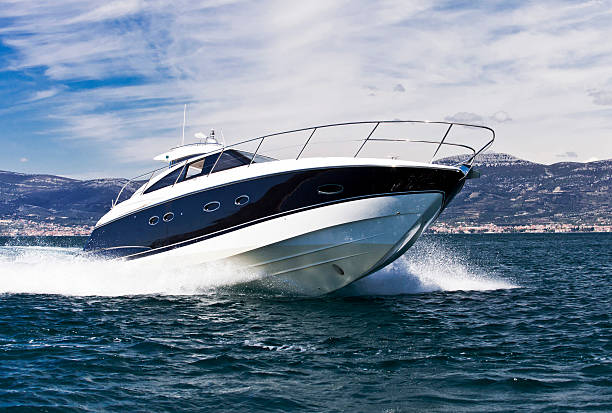 A blue striped white yacht speeding across the sea Luxurious yacht speedboat riding on a sea motorboat stock pictures, royalty-free photos & images