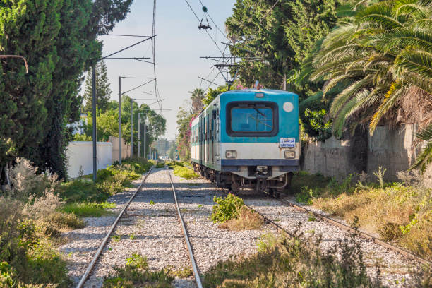 Blue TGM train goes between La Goulette and Carthage. Carthage, Tunisia stock photo
