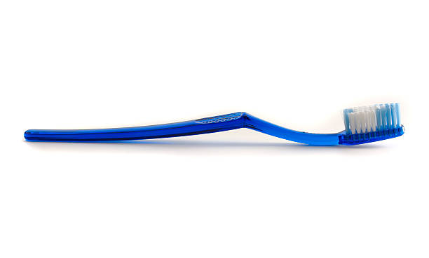 A blue toothbrush with white and blue bristles  stock photo