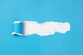 istock Blue Torn paper with ripped edges stock photo 1312343347