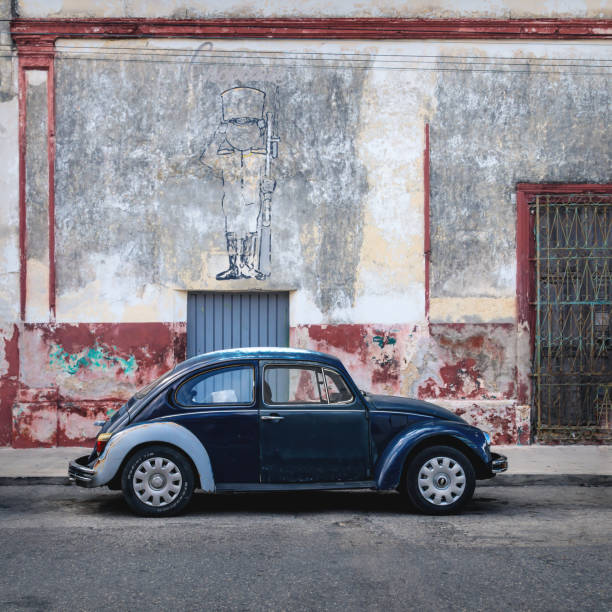 Blue Volkswagen Beetle in the colonial street of Merida, Yucatan, Mexico stock photo
