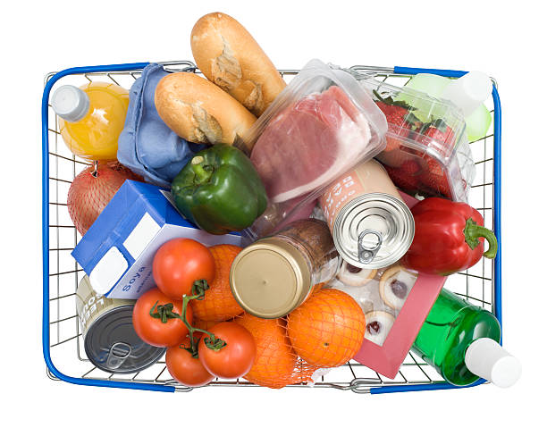Blue wire shopping basket filled with a variety of groceries stock photo