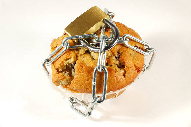 blueberry muffin chained "Blueberry muffin chained and lock. Pro diet, anti fat or sugar theme." banned food stock pictures, royalty-free photos & images