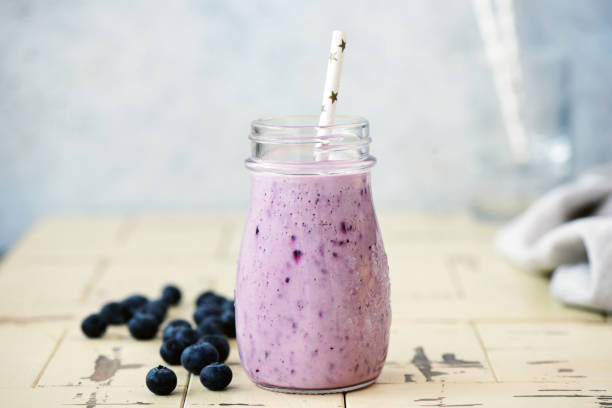 Blueberry smoothie in bottle Blueberry smoothie in bottle with drinking straw. Fresh delicious berry smoothie. Vegan, vegetarian diet concept, clean eating and weight loss smoothie stock pictures, royalty-free photos & images