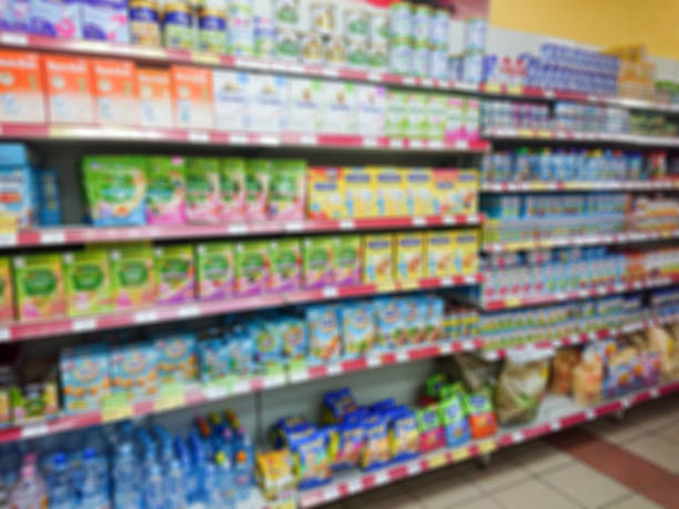 Blurred abstract image. Goods on the shelf of a grocery store. Different baby food Blurred abstract image. Goods on the shelf of a grocery store. Different baby food. baby formula stock pictures, royalty-free photos & images