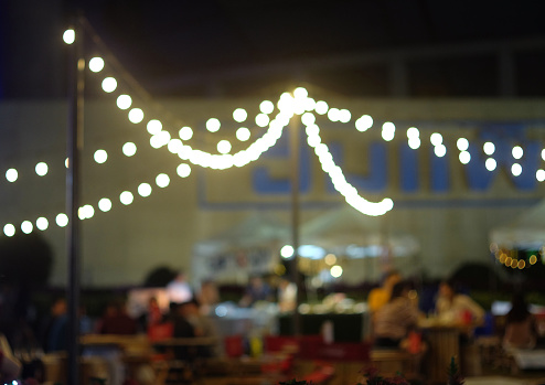 Abstract blurred background of beer garden festival at night with bokeh.