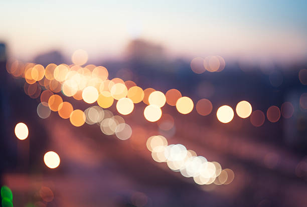 Blurred defocused lights of traffic in the city Blurred defocused colorful lights of traffic in the city street light stock pictures, royalty-free photos & images