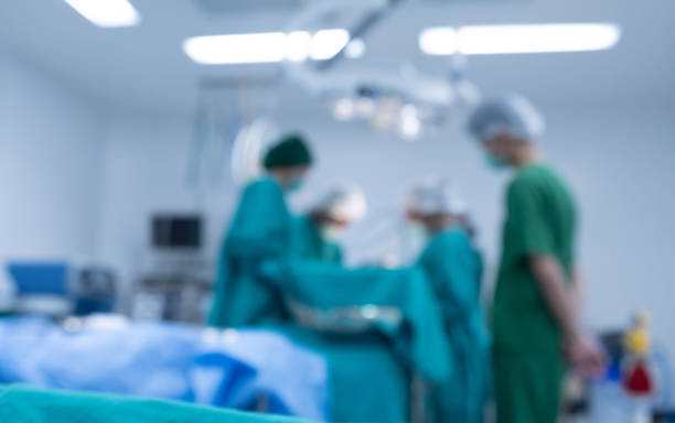 Blurred image background of medical team performing surgical operation in operating room. stock photo
