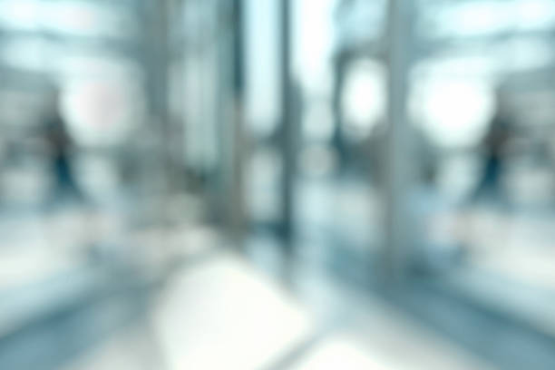Blurred office background Defocused background of an office space with glass windows illuminated by bright sunlight. Blurred scene with no people. looking through window photos stock pictures, royalty-free photos & images
