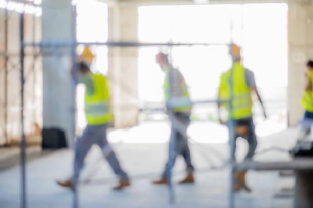 Blurred workers on a construction site stock photo