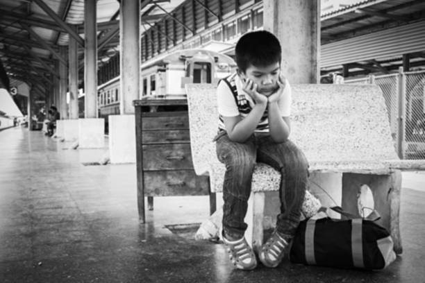 blurry abstract of the little boy sitting alone - teddy ray stok fotoğraflar ve resimler