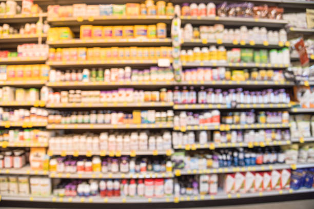 Blurry background variation of supplements with price tags at vitamin store in USA Blurred image of vitamin store shelves with huge variation of vitamins and supplements, natural remedies, functional food, lifestyle support, and herbal. Medical supplies product abstract background. steroidshop stock pictures, royalty-free photos & images