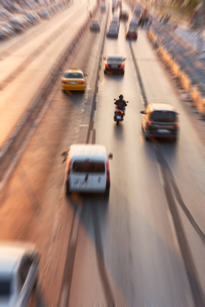 Blurry image of rush hour traffic on busy highway at sunset stock photo