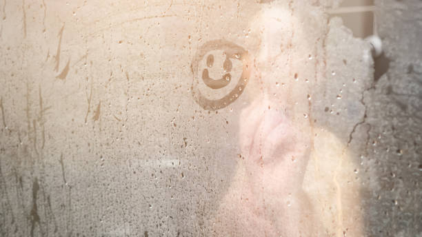 blurry naked lady draws smile on white condensate close stock photo