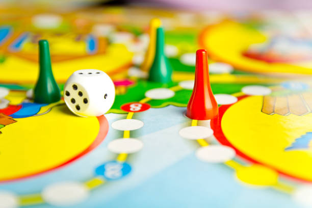 Board games for the home. Yellow, green and red plastic chips and dice on Board games for children . Selective focus stock photo