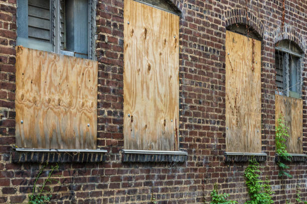 Boarded up windows on red brick building left abandoned in Atlanta stock photo