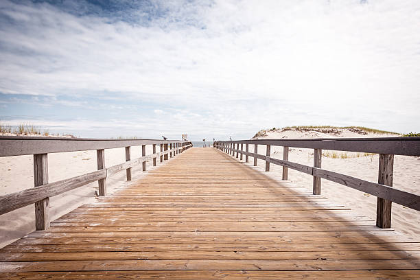 Boardwalk leading onto the beach Shot in New Jersey, August 2014 boardwalk stock pictures, royalty-free photos & images