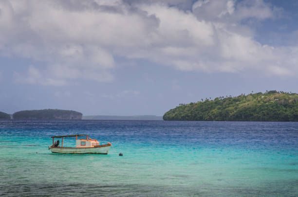 boat at the white sand beaches in the kingdom of Tonga stock photo