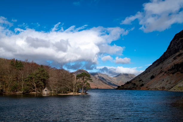 Boat House on Wast Water with Great Gable Scenic in English Lake District looking to mountains over Wast Water with boathouse on the water and large Yew Tree at waters edge. yew lake stock pictures, royalty-free photos & images