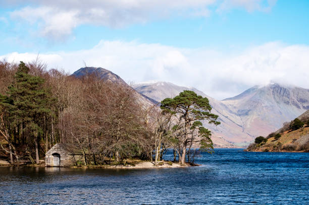 Boat House on Wast Water with Great Gable Scenic in English Lake District looking to mountains over Wast Water with boathouse on the water and large Yew Tree at waters edge. yew lake stock pictures, royalty-free photos & images