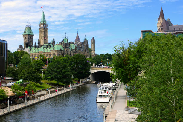Boat lined Rideau Canal towards Parliament Hill, Ottawa, Ontario, Canada stock photo