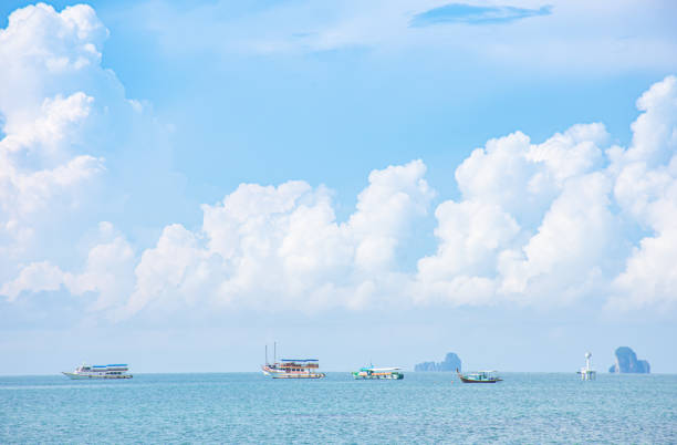 boat tours in the sea  background Island and clouds on the sky  at Krabi in Thailand stock photo