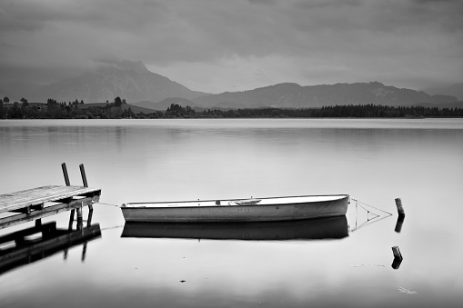Boat With Dock On Mountain Lake Black And White Stock Photo - Download ...