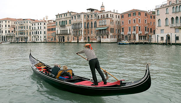 Boatman in a gondola on the Grand Canal in Venice stock photo