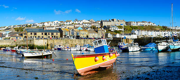 Boats moored in the harbour of Porthleven Cornwall UK stock photo
