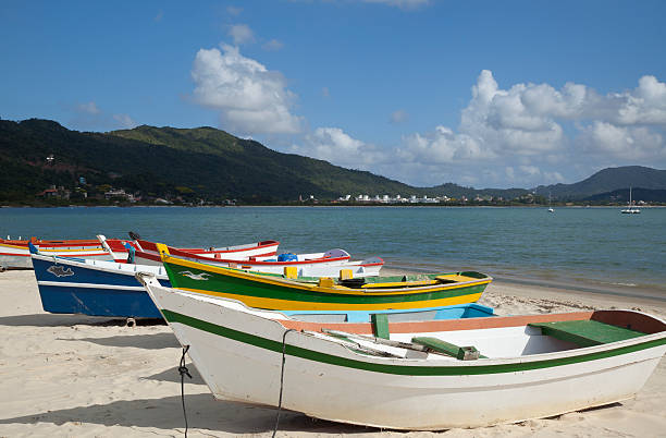 Boats on a Beach Next to the Ocean stock photo