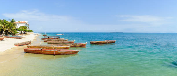 Boats on beach of Indian Ocean in Zanzibar stock photo