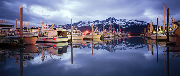Boats on Smooth Reserection Bay Seward Alaska Harbor Marina It's very calm with no one around in Seward in the Land of the Midnight Sun kenai peninsula stock pictures, royalty-free photos & images
