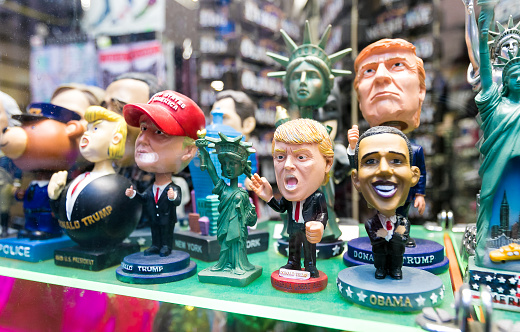 Figurines of contemporary US presidents are displayed in a store window.