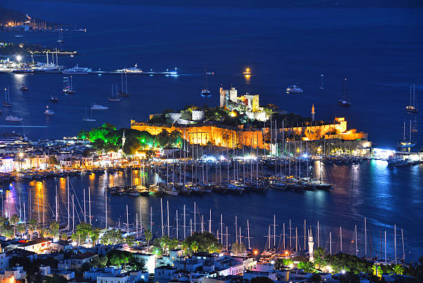 Bodrum harbor and Castle of St. Peter after sunset stock photo