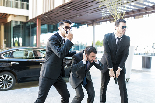 Bodyguards Safeguarding Scared Boss From Attack Stock Photo - Download  Image Now - iStock