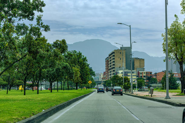 Bogotá, Colombia - Driver's Point Of View, Driving Eastwards On A Service Road That Joins Calle 26. Background: The Eastern Hills In The Capital City. stock photo