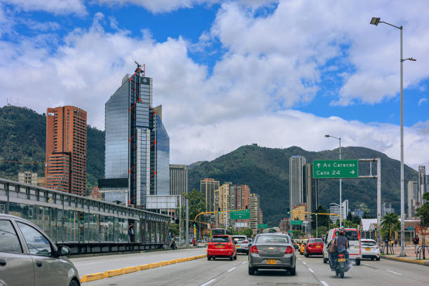 Bogotá, Colombia - Driver's Point Of View, Driving Eastwards On Avenida El Dorado Or Calle 26. Background: The Eastern Hills In The Capital City On An Overcast Afternoon stock photo