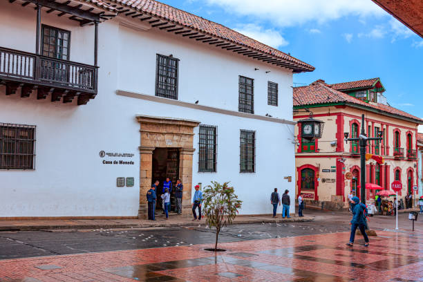 Bogotá Colombia - Looking Across Calle 11 in La Candelaria Towards the Entrance To The Casa de Moneda. Spanish Colonial Architecture And A Little Rain. stock photo