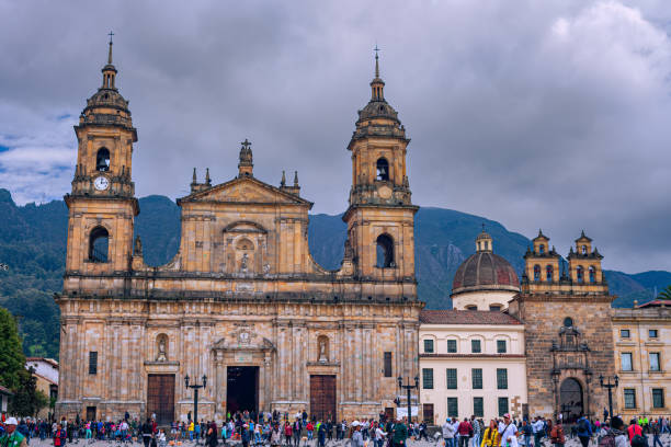 Bogota, Colombia - The Northeastern Corner Of Plaza Bolivar in the South American Capital City with Ninteenth Century Catedral Primada and Capilla Del Sagrario. Background: The Andes Mountains. stock photo