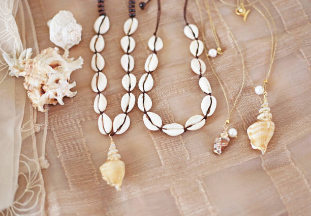 bohemian summer jewelry with shells - cowrie shells necklaces - fashion jewelry advertisement stock photo