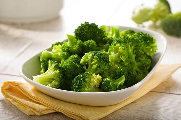 boiled broccoli in a bowl stock photo
