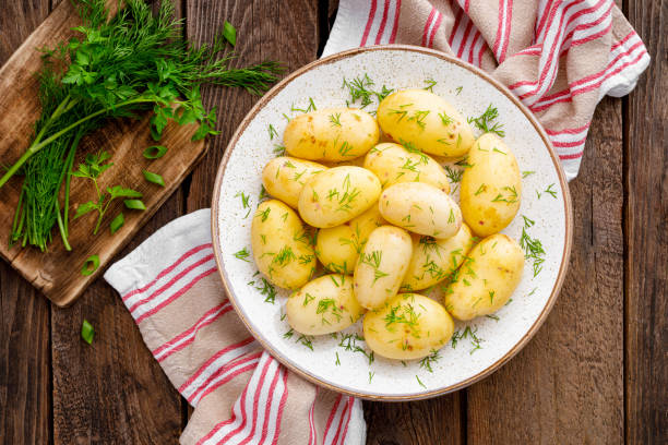 Boiled new potato with butter, dill and green onion Boiled new potato with butter, dill and green onion dill photos stock pictures, royalty-free photos & images