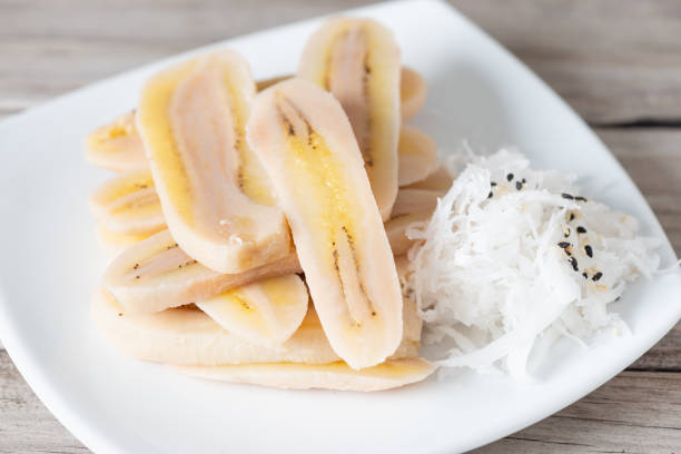 Boiled slice banana eat with coconut stock photo
