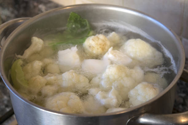 boiling culiflower boiling organic cauliflowers in a metallic pot boiled stock pictures, royalty-free photos & images